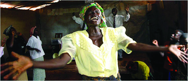 October 19, 2003, Mulungu-Lungu, Congo: Women sing and pray fervently at the revivalist Victory Church of Congo in Mulungu-Lungu. Pentacostal churches in Congo often perform exorcisms for people believed to possessed by the devil.. Credit: Evelyn Hockstein / Polaris